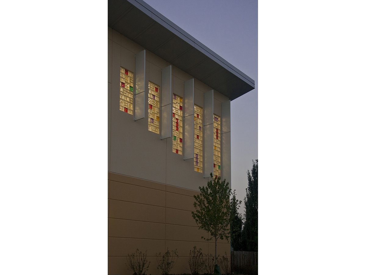 Colored glass block windows with sun shades at dusk